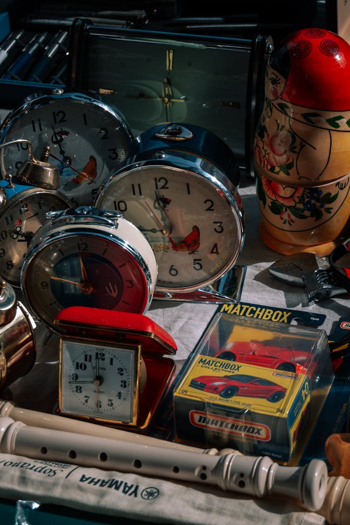 Crafting Captivating Headlines: Your awesome post title goes here A collection of vintage clocks, a Russian doll, and Matchbox car for sale at an indoor market.